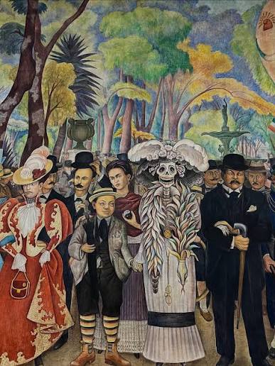 La Catrina junto a Diego Rivera niño, Frida Kahlo y José Guadalupe Posada en el mural Sueño de una tarde dominical en la Alameda Central.