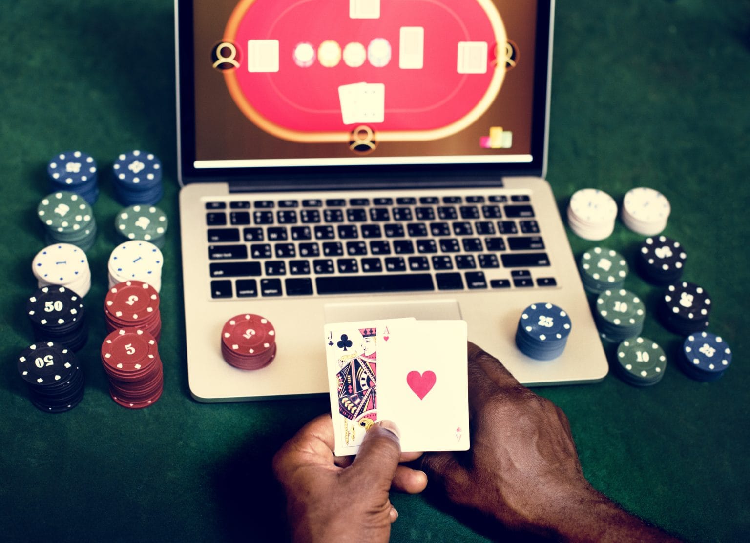 hand-holding-card-playing-online-gambling-PQMW49K-1536x1113.jpg