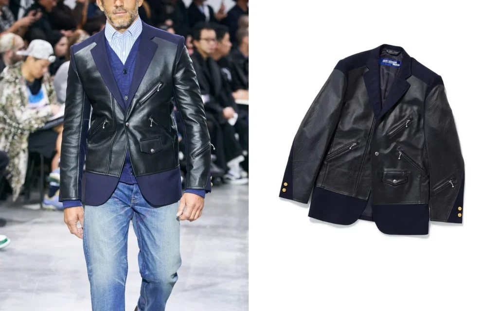 Blazer azul marino de Brooks Brothers x Junya Watanabe MAN con paneles frontales y mangas de cuero negro estilo chamarra de motociclista, bolsillos con cremallera y botones dorados.