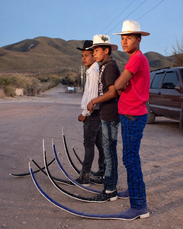 Tres tribaleros de Matehuala posan con sombreros vaqueros y botas picudas de puntas extralargas asociadas al tribal mexicano.